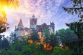 Landscape with medieval Bran castle known for the myth of Dracula at sunset Royalty Free Stock Photo