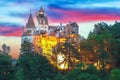 Landscape with medieval Bran castle known for the myth of Dracula at sunset Royalty Free Stock Photo