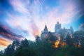 Landscape with medieval Bran castle known for the myth of Dracula at sunset Royalty Free Stock Photo