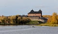 A landscape of a medieval castle in autumn