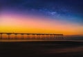 Landscape with Milky way galaxy and Sunset over pier at Saltburn by the Sea, North Yorkshire, UK. Royalty Free Stock Photo