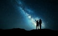 Landscape with Milky Way. Silhouette of a father and son