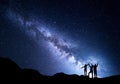 Landscape with Milky Way and silhouette of a happy family Royalty Free Stock Photo