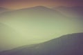 Landscape of misty mountain hills covered by forest. Royalty Free Stock Photo