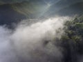 Landscape misty panorama. Fantastic dreamy sunrise on rocky mountains with view into misty valley below. Foggy clouds above Royalty Free Stock Photo