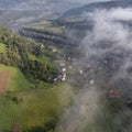 Landscape misty panorama. Fantastic dreamy sunrise on rocky mountains with view into misty valley below. Foggy clouds above Royalty Free Stock Photo