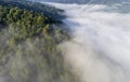 Landscape misty panorama. Fantastic dreamy sunrise on rocky mountains with view into misty valley below. Foggy clouds above Royalty Free Stock Photo