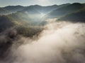 Landscape misty panorama. Fantastic dreamy sunrise on rocky mountains with view into misty valley below. Foggy clouds above Royalty Free Stock Photo