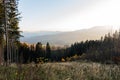 Landscape misty panorama. Fantastic dreamy sunrise on rocky mountains with view into misty valley below. Foggy clouds above Royalty Free Stock Photo