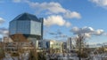 Landscape with modern National library building in Belarus on classic blue sky with clouds background. Space for text.