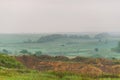 Landscape in morning. Hills, clay ground, green hills in morning mist