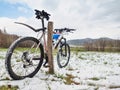 Landscape with a mountain bike in front view with a blue hard hat on the handlebars