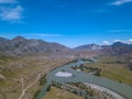 Landscape of the mountain chain of the Altai covered with green trees and rocks, with the turquoise Katun River and its rapids on Royalty Free Stock Photo