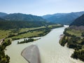 Landscape of the mountain chain of the Altai covered with green trees and rocks, with the turquoise Katun River and its rapids on Royalty Free Stock Photo