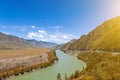 Landscape of the mountain chain of the Altai covered with green trees and rocks, with the turquoise Katun River and its rapids on Royalty Free Stock Photo