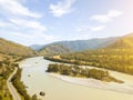 Landscape of the mountain chain of the Altai covered with yellow trees and rocks, with the turquoise Katun River and its rapids on Royalty Free Stock Photo