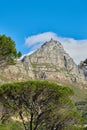 A landscape of a mountain with a cloudy blue sky background and copy space. Peaceful and scenic view of a summit near