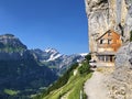 Landscape of the mountain Ebenalp and the mountain restaurant under the Ascher cliff in the Appenzellerland region Royalty Free Stock Photo