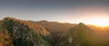 Landscape of mountain in the morning with sun light. Wind turbine on the top of mountain. Renewal energy. Green energy concept.