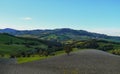 Landscape in the mountains across blue sky. Lonely tree across green mountains. Natural background. Copy space Royalty Free Stock Photo