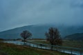 Landscape of mountains with cloudy sky and fog on a cloudy day. Autumn rainy day Royalty Free Stock Photo