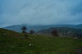 Landscape of mountains with cloudy sky and fog on a cloudy day. Autumn rainy day Royalty Free Stock Photo