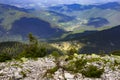 Landscape of mountains covered with green firs. Alpine pines grow among the rocks on top of the mountain against the backdrop of Royalty Free Stock Photo