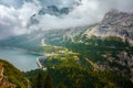 landscape with mountains, Fedaia lake, clouds and forest Royalty Free Stock Photo