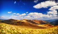 Landscape mountains and field under blue sky Royalty Free Stock Photo