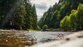 Landscape with mountains, forest and a river in front. beautiful scenery Royalty Free Stock Photo