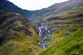 Landscape of mountains with green hillside and a small waterfall in Snowdonia, Wales Royalty Free Stock Photo