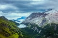 landscape with mountains, hills, Fedaia lake, clouds and forest Royalty Free Stock Photo