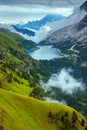 landscape with mountains, hills, Fedaia lake, clouds and forest Royalty Free Stock Photo