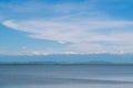 Landscape with a blue lake and mountain peaks covered with snow. Royalty Free Stock Photo