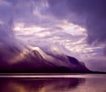 Landscape. Mountains and lake in mist in morning with purple color