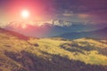 Landscape in the mountains:snowy tops and spring valleys. Fantastic evening glowing by sunlight. Royalty Free Stock Photo