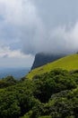 Landscape of the Mullayanagiri Peak touching the clouds in Karnataka, India. Vertical shot