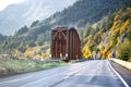 Landscape with a narrow railway bridge next to a highway with autumn yellow trees on rocks in Columbia River Gorge Royalty Free Stock Photo