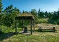 Landscape with a naturally decorated seating area, wooden table and bench, summer landscape