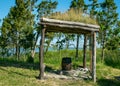 Landscape with a naturally decorated seating area, wooden table and bench, summer landscape