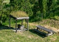 Landscape with a naturally decorated seating area, wooden table and bench, summer landscape