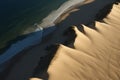 Abstract and surreal landscape view of sand dunes and blue water