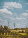 Landscape nature rice field with high voltage pole in middle field and beautiful blue sky and clouds Royalty Free Stock Photo