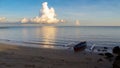 Landscape nature sunrise scenery of seacoast,fishing boat & clouds at Batu Manikar beach,Labuan,Malaysia.