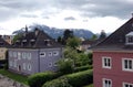 Landscape with nice town houses and high inaccessible snow mountains at far in gloomy day
