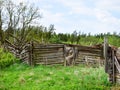 Old and collapsed country house, collapsed wall and old wooden logs