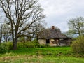 Old and collapsed country house, collapsed wall and old wooden logs