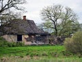 Old and collapsed country house, collapsed wall and old wooden logs