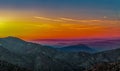 Landscape with orange and purple silhouettes of mountains, hills and forest Royalty Free Stock Photo