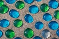 White, blue and green glass beads on sand Royalty Free Stock Photo